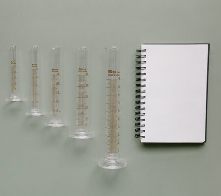 Notebook and Graduated Vials by Tara Winstead